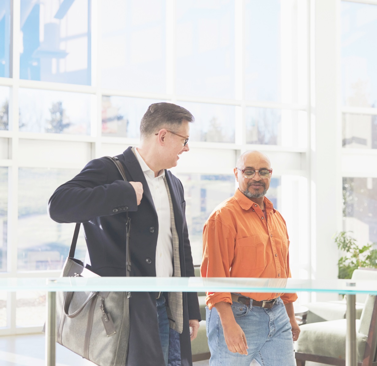 Two men walking and chatting