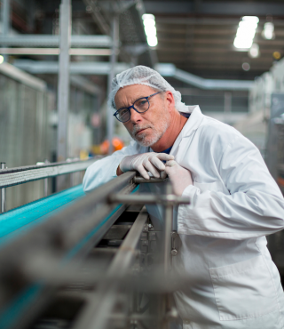 Man in overalls on food production line